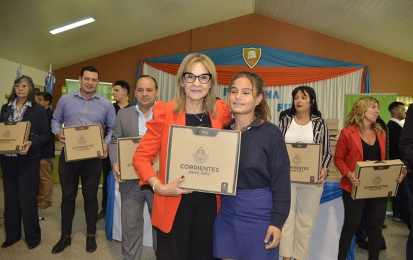 Ministra de Educación Práxedes López entregando notebook a alumna de secundaria