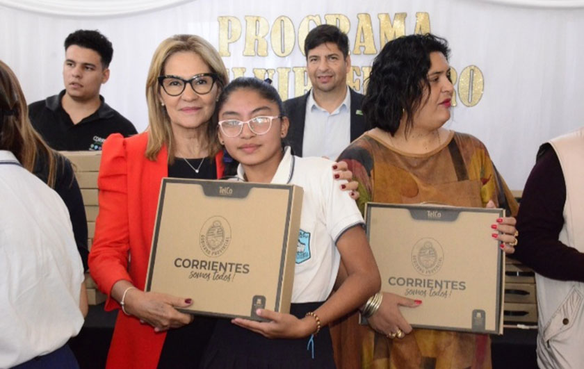 Ministra de Educación Práxedes López entregando notebook a alumna de secundaria